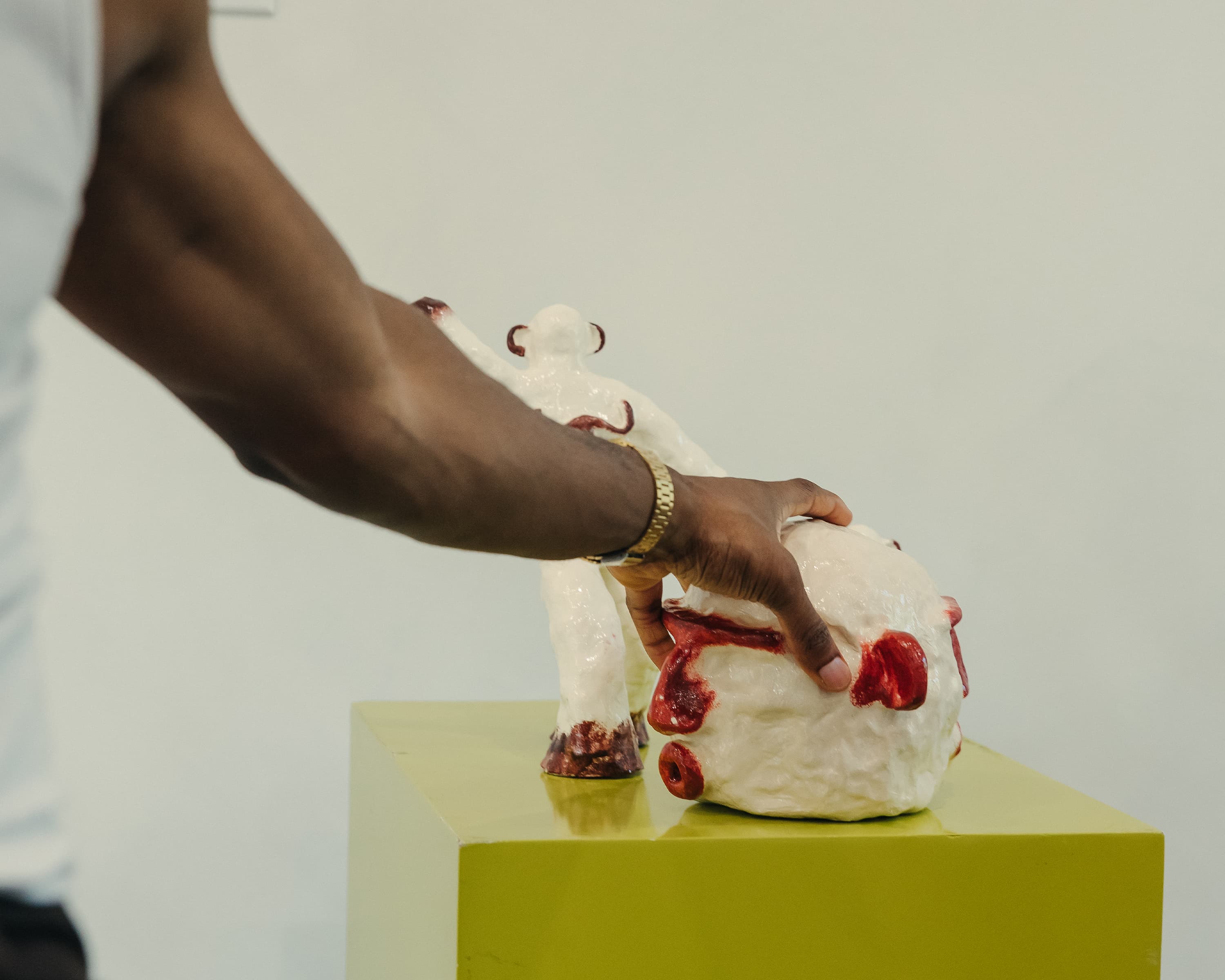A hand-molded sculpture being placed on its plinth